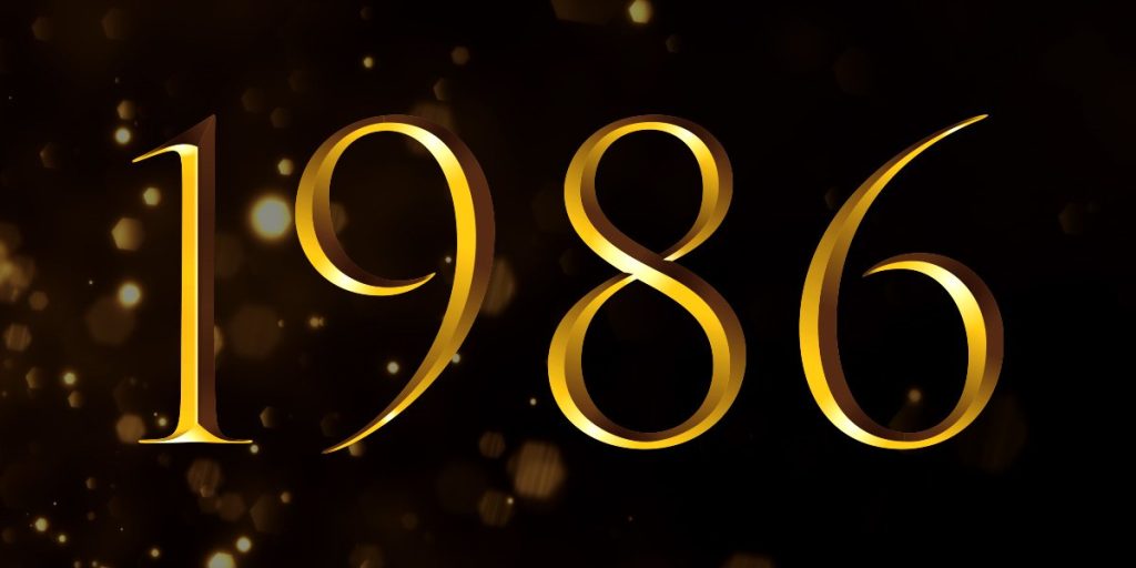 Golden numbers "1986" on a black background, with subtle sparkles enhancing the celebratory theme.