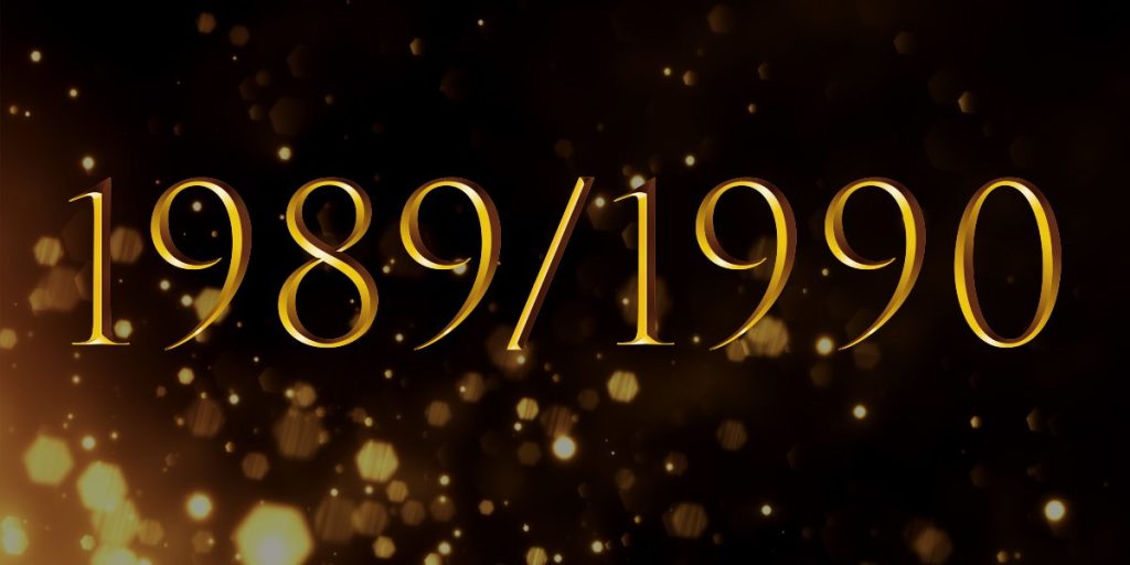 Gold text reading "1989/1990" on a dark background with sparkling bokeh effects.