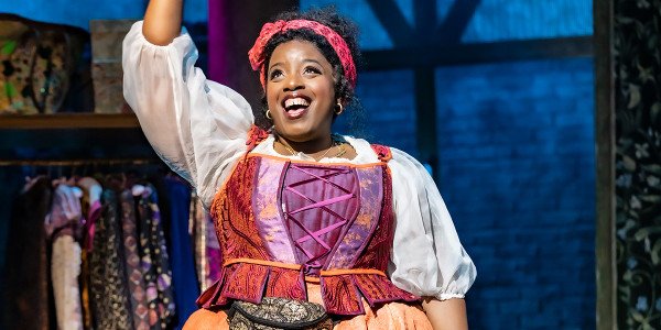 Malinda Parris smiling with a hand in the air