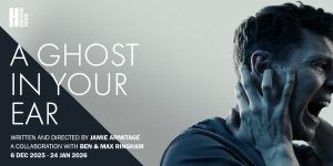 The background is black and white with a horizontal split in the centre. On the left it reads 'A Ghost In Your Ear' on the right is an image of a person who is holding a hand to their face and appears to be screaming.