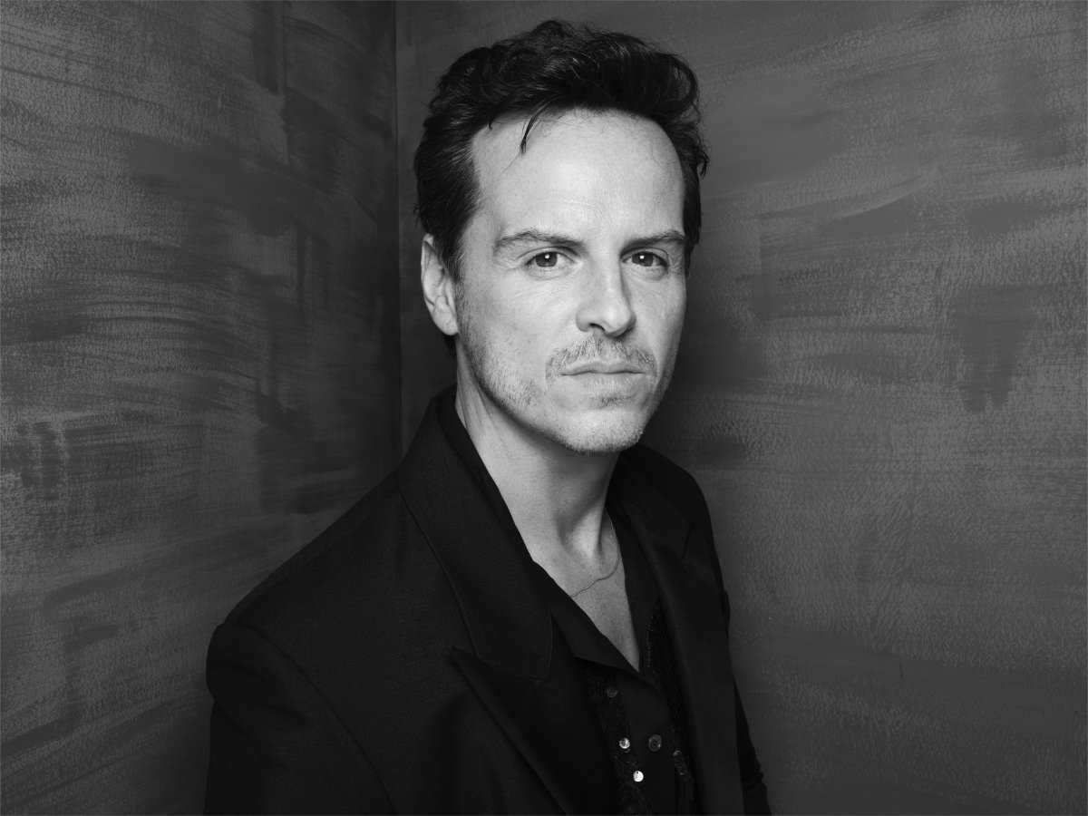 A man looking to the camera with his body angled slightly away.