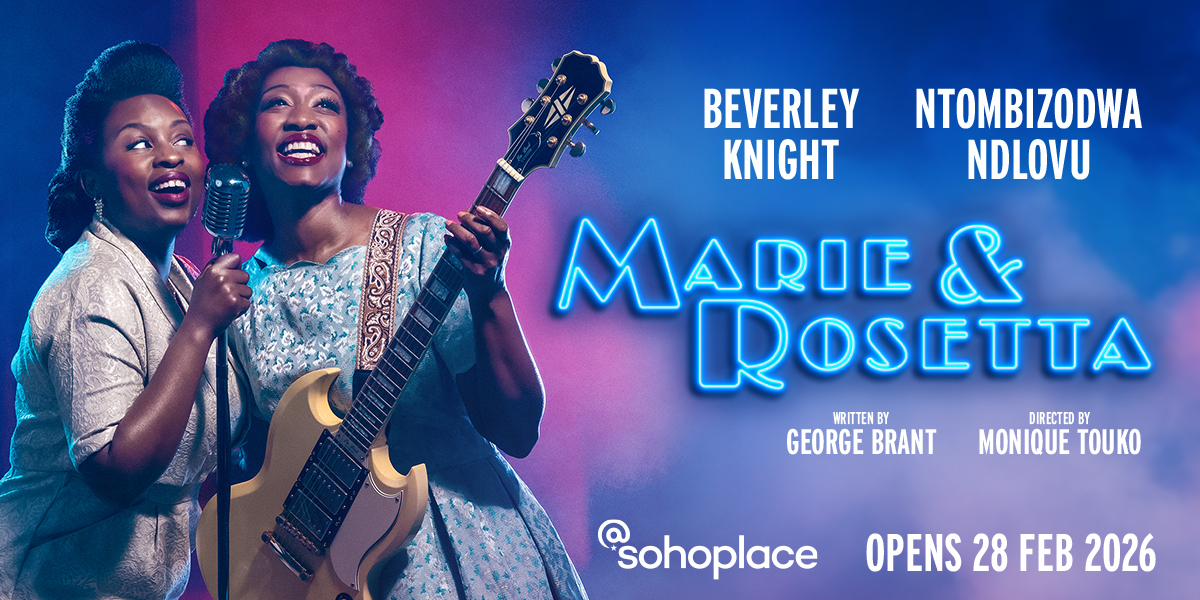 Two women in elegant dresses perform on stage, surrounded by warm lighting and a dark backdrop.