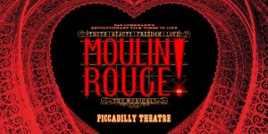 A vibrant stage scene from Moulin Rouge! featuring performers in elaborate costumes, dramatic lighting, and a colourful backdrop.