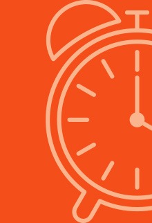 A vibrant theatre scene with people seated, enjoying a performance on stage, illuminated by soft lighting.