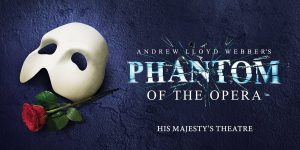 A white mask and a red rose against a textured dark blue background, featuring promotional text for the musical.