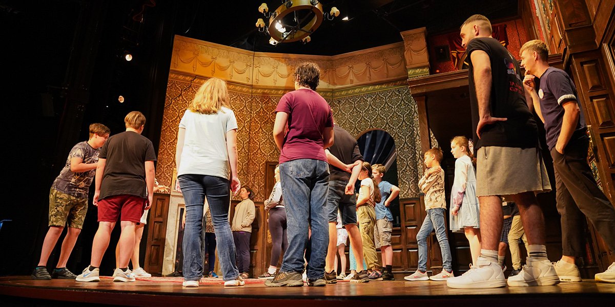 Children enjoying the Kids Week stage combat workshop at The Play That Goes Wrong